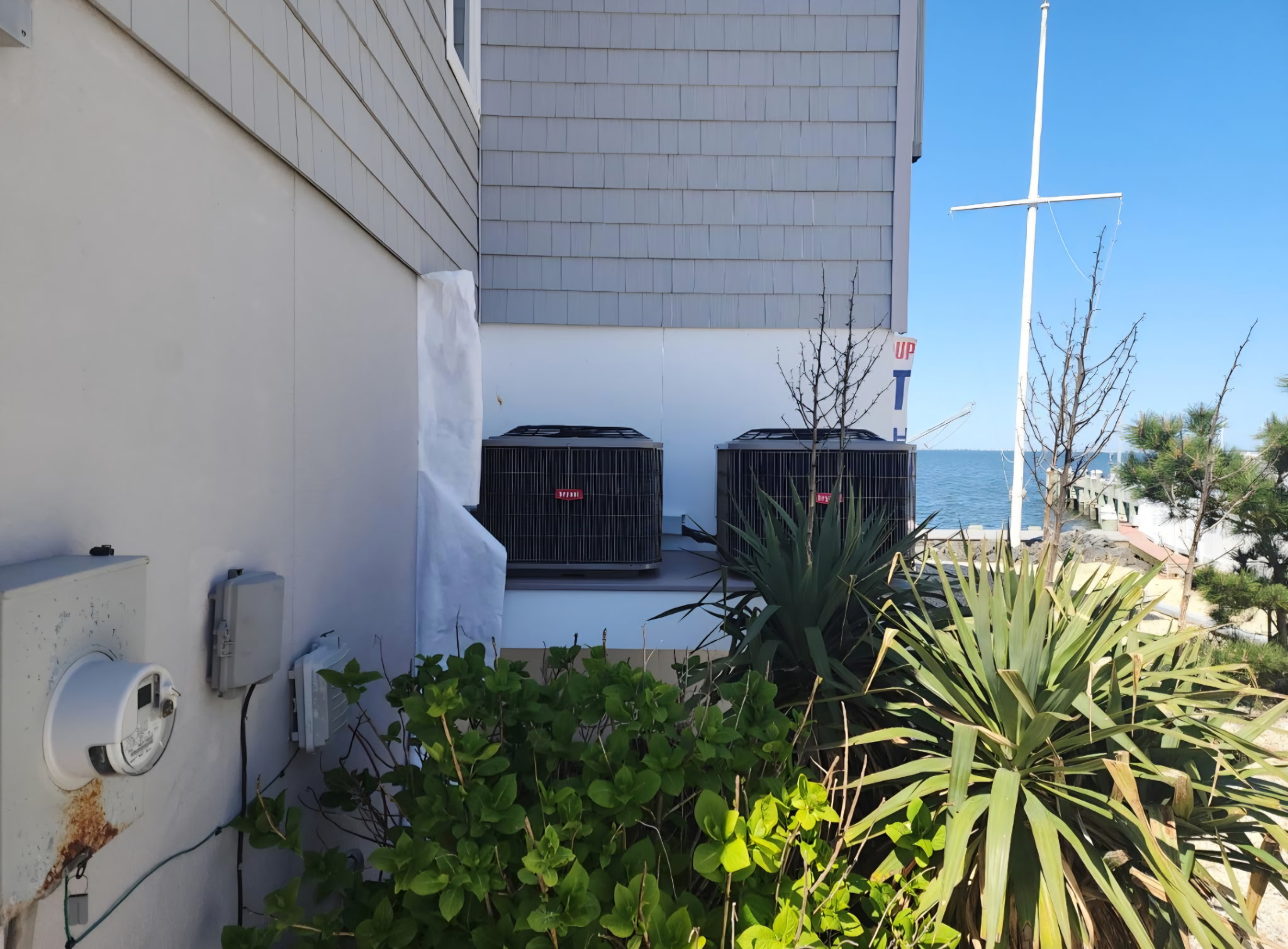 Two Bryant AC condensers on a home near the water.